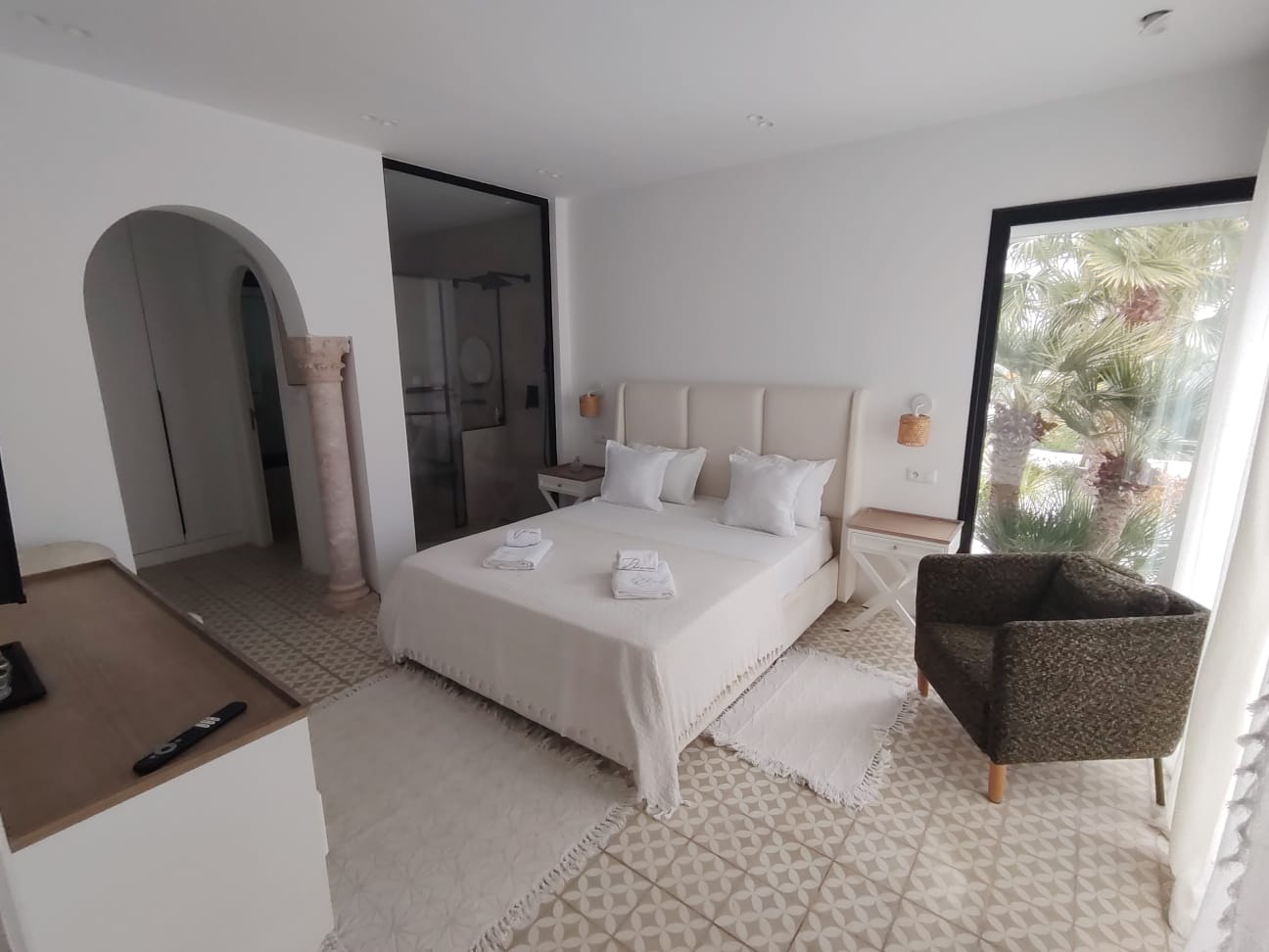 Bedroom with palm garden view and ensuite bathroom